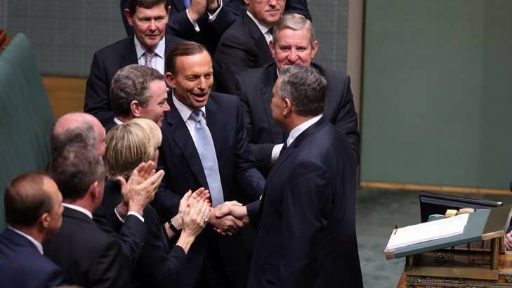 Enjoying the moment ... Tony Abbott and his ministers congratulate Joe Hockey after the Treasurer delivered his first budget speech. Photo: Andrew Meares