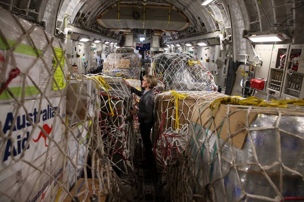 Former Foreign Affairs minister Julie Bishop inspects Australian aid supplies onboard a C17 bound for Vanuatu in 2015. A 2018 survey showed many Australians vastly overestimate the amount of aid Australia sends overseas. Photo: Andrew Meares