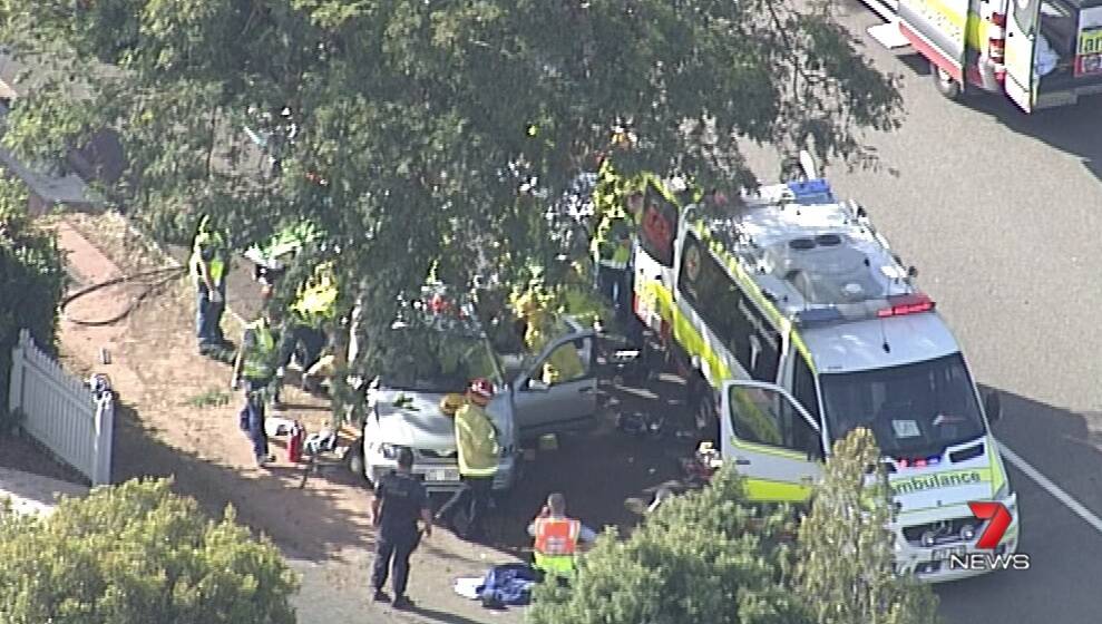 The crash scene in Murrumba Downs after a car lost control on a roundabout and hit a tree. Photo: 7 News Brisbane - Twitter