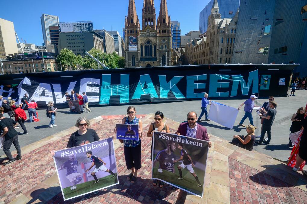 Protesters set up for a rally for Hakeem al-Araibi in Melbourne on Friday. Photo: Justin McManus