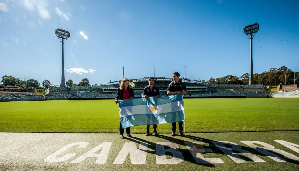 ACT minister for sport and recreation Yvette Berry and ARU general manager Rob Clarke with Tomas Cubelli at Canberra Stadium on Monday. Photo: Karleen Minney
