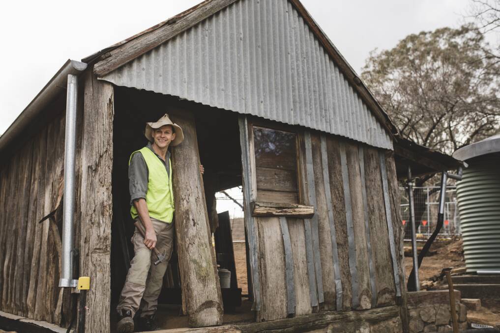 Traditional bush craftsman Myles Gostelow outside a slab shed that he is restoring on the site of the historic Blundell's Cottage. Photo: Jamila Toderas
