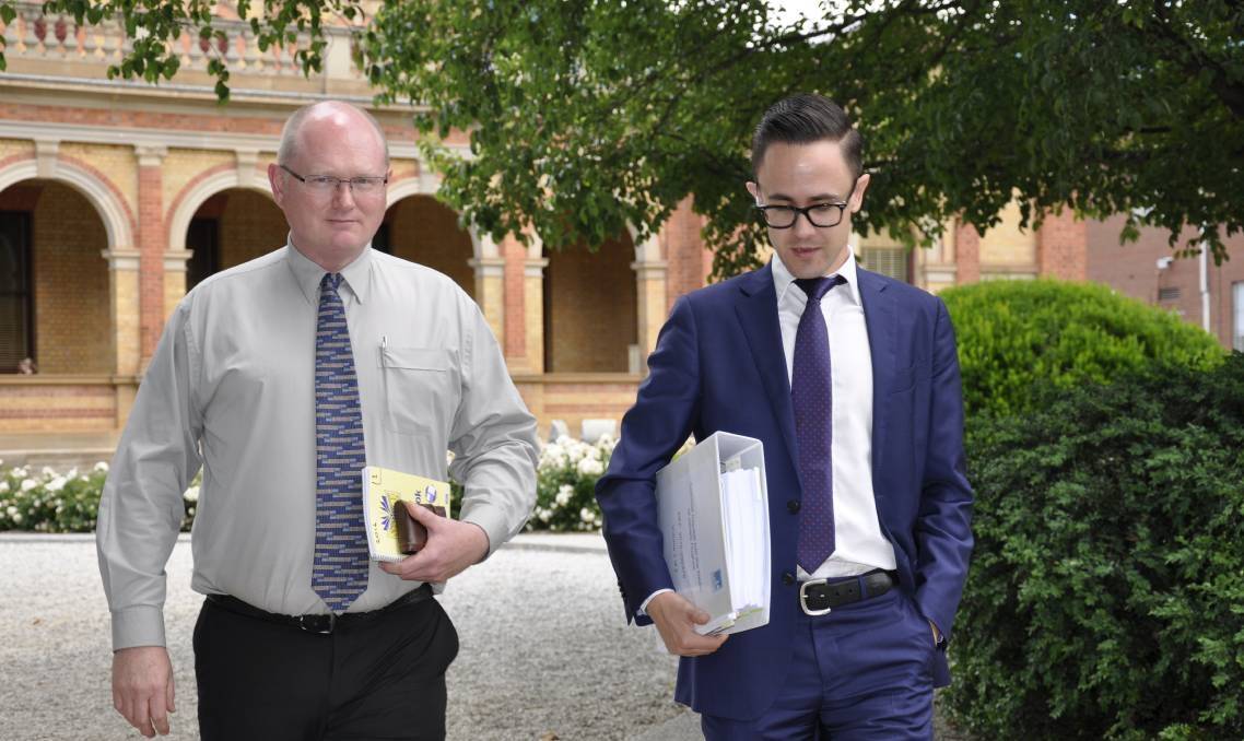 Former Goulburn Mulwaree Council works manager Andrew Palmer leaves Goulburn Courthouse with his legal representative on Wednesday. Photo: Goulburn Post