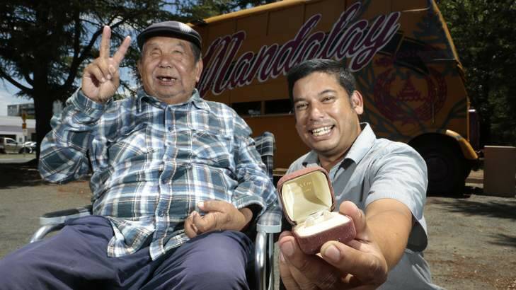 Mandalay Bus owners George Thaung and his son Stewart with a pair of opals given to them by a former homeless man, who had been helped by George before finding the gems at Lightning Ridge. Photo: Jeffrey Chan