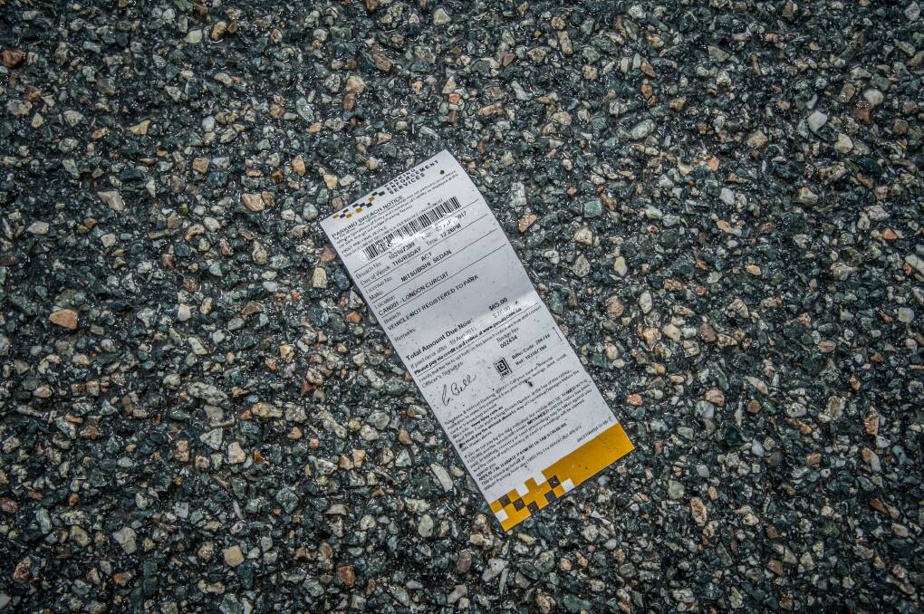 A discarded Wilson Parking infringement fine in the Wilson carpark at London Circuit. Photo: Karleen Minney