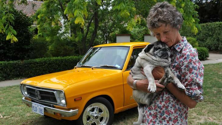 Janey Wallace at her home in Reid with her pet pug Oscar and her late son (Lachlan's) car. Photo: Graham Tidy