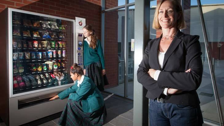 Vital Vending's Melinda Moss with Canberra Girls Grammar students and one of her healthy vending machines. Photo: Katherine Griffiths