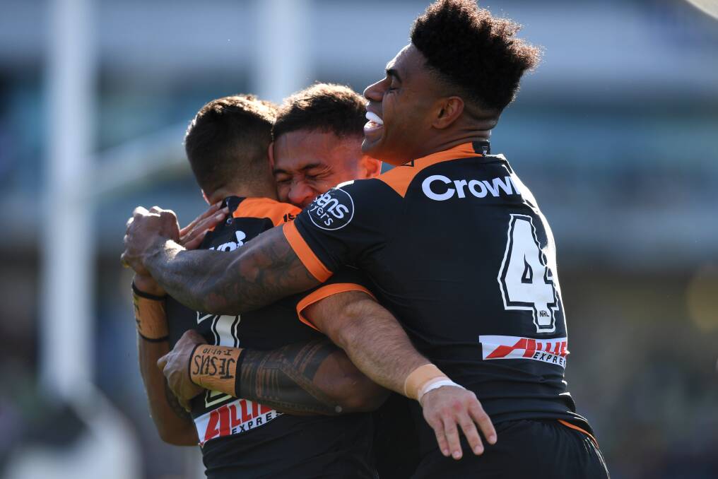 Michael Chee Kam of the Wests Tigers celebrates after scoring a try. Photo: Lukas Coch
