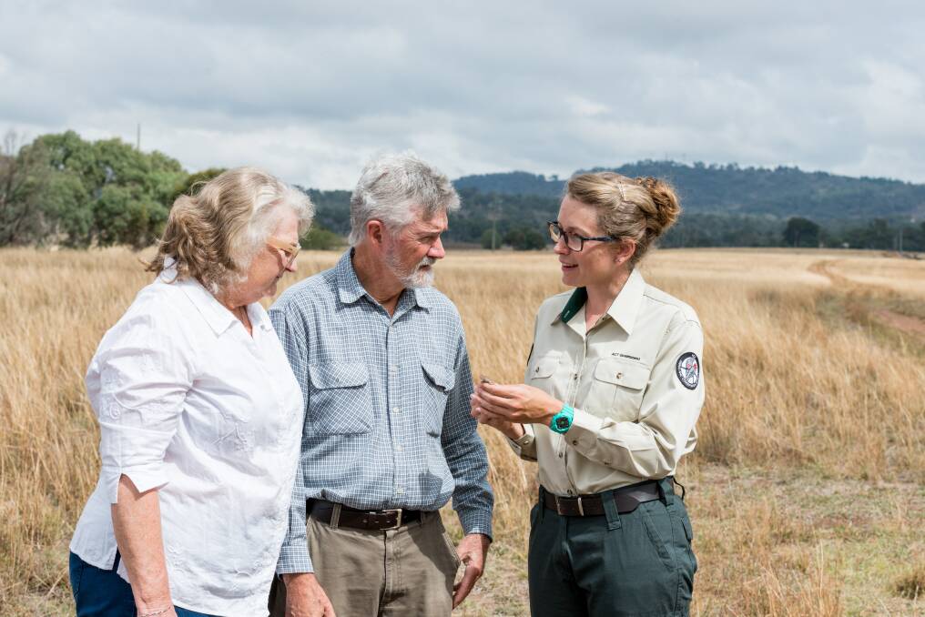 Property owners Jen and Peter Ipkendanz talk to ACT Parks and Conservation Ecologist Emma Carlson about grassland earless dragon conservation. Photo: Cathy Jackway