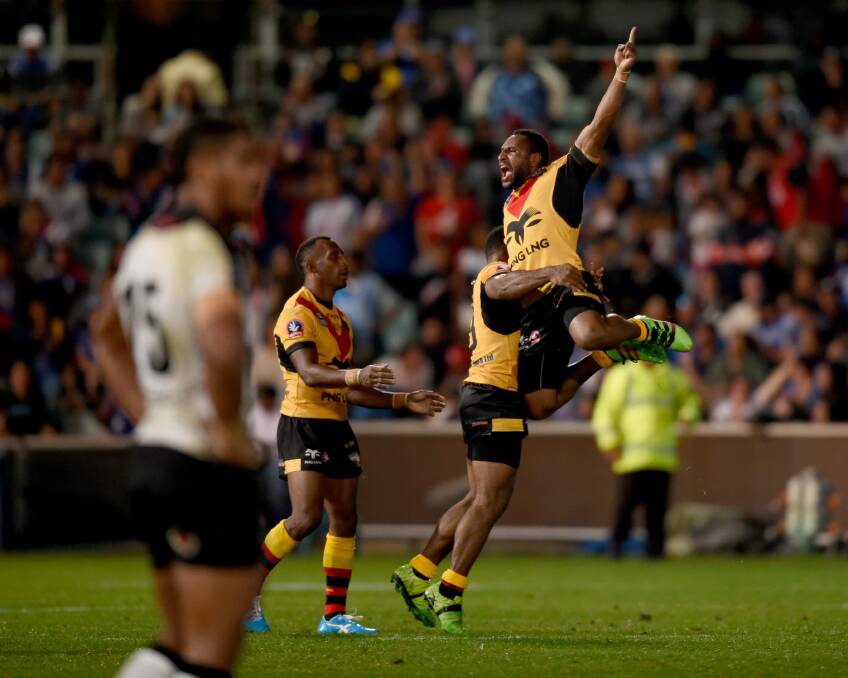 Triumph: Justin Olam celebrates his try for the Kumuls against Fiji. Photo: AAP