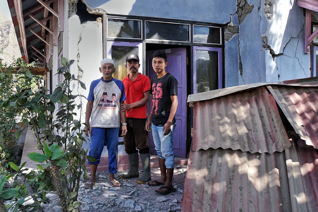 From left: Kurniadi, Hasbi Haer and Ahmad Munadi outside their damaged house in Sembalun Bumbung. Photo: Amilia Rosa