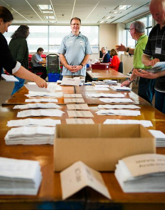 Electoral Commissioner Phillip Green counting postal votes in October last year.  Photo: Elesa Kurtz