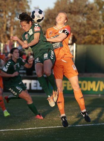Canberra United's Ashleigh Sykes attacks the ball ahead of Brisbane Roar player Clare Polkinghorne. Photo: Jeffrey Chan
