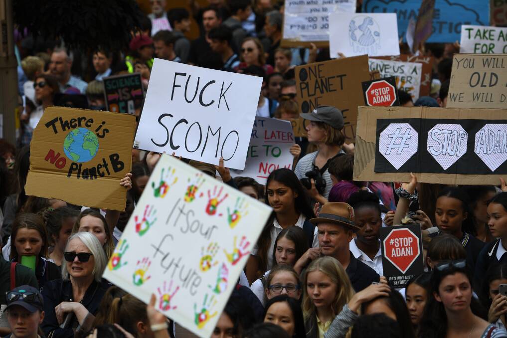 A few of the signs held during student climate strikes directly targeted Prime Minister Scott Morrison. Photo: AAP