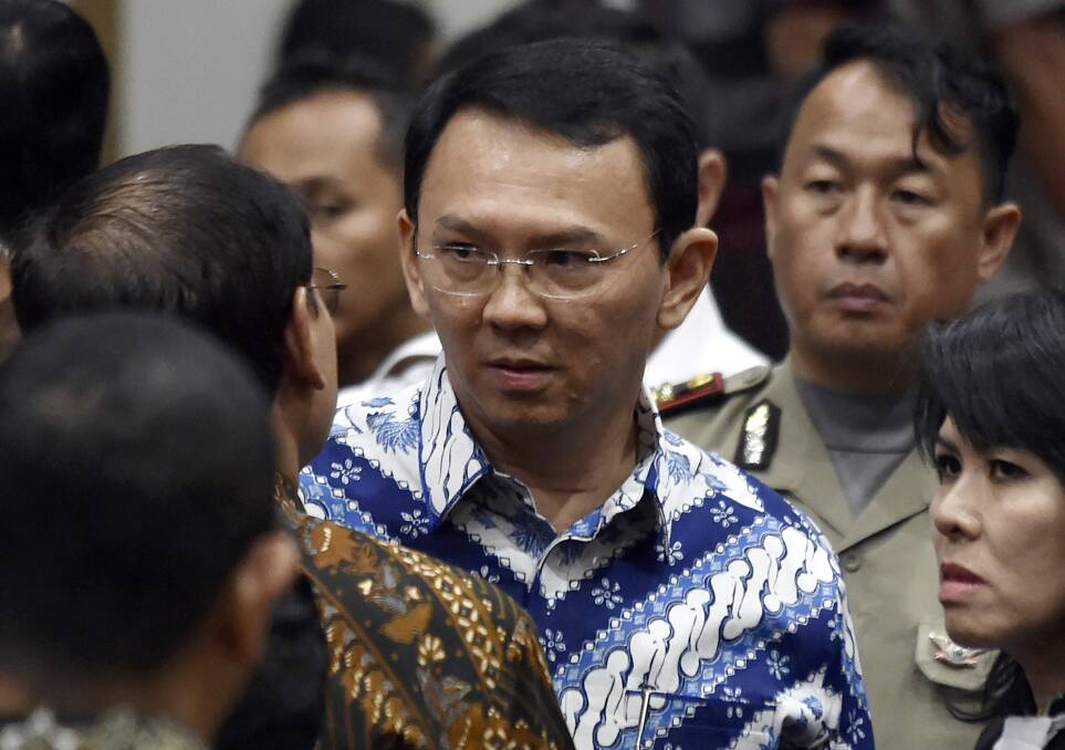Former Jakarta governor Basuki "Ahok" Tjahaja Purnama talks to his lawyers after his sentencing in May last year. Photo: AP
