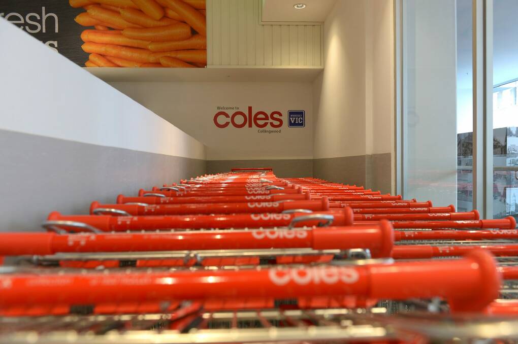 Rows of shopping trolleys stand at a Coles supermarket. Photo: Carla Gottgens