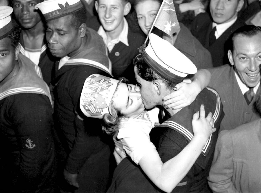 Sydney celebrated the end of the war in high style. A woman kisses a sailor in Martin Place. Photo: F.J. Halmarick