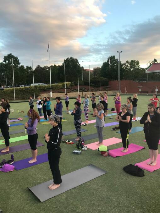 Yoga under the stars was held on the lawn bowling greens at Town Centre Vikings in Tuggeranong to kickstart fundraising for OzHarvest Canberra. Photo: supplied