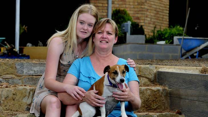Fiona Vickery of Yass, with her daughter Skye, 16 and the family dog Jasper. Fiona's husband was killed in a workplace accident in December 2011. Photo: Melissa Adams