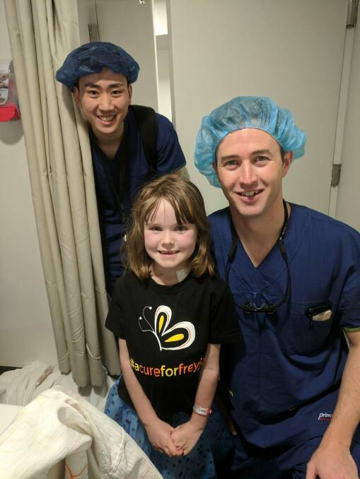 Canberra girl Freyja Christiansen says goodbye to doctors in Melbourne including Dr Ben Dixon (right) who performed the Australia-first operation on her. Photo: supplied