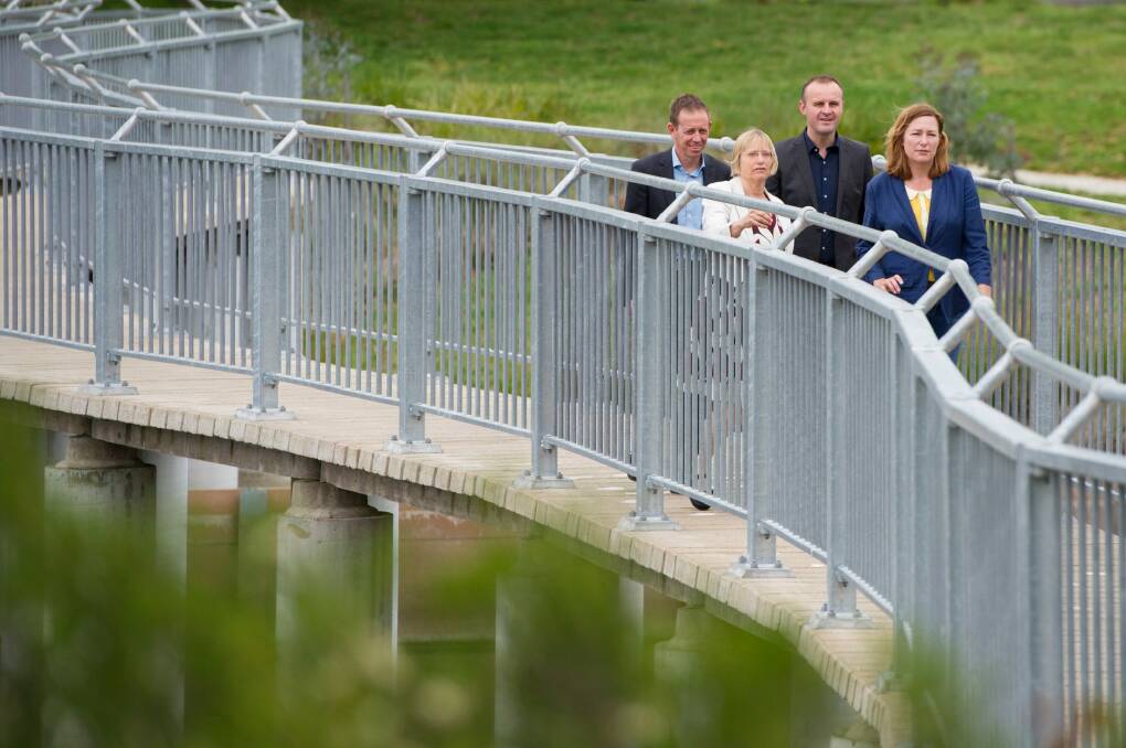 The Greens' Shane Rattenbury and Caroline Le Couteur with ACT Chief Minister Andrew Barr and deputy Yvette Berry announcing the parliamentary deal at the Lyneham wetlands on Sunday. Photo: Jay Cronan