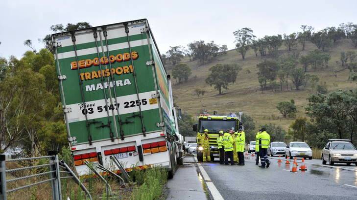 A truck that lost control on the Federal Highway northbound lanes, near the ACT/NSW border.  It damaged some safety fencing and spilled fuel on the road. Photo: Graham Tidy