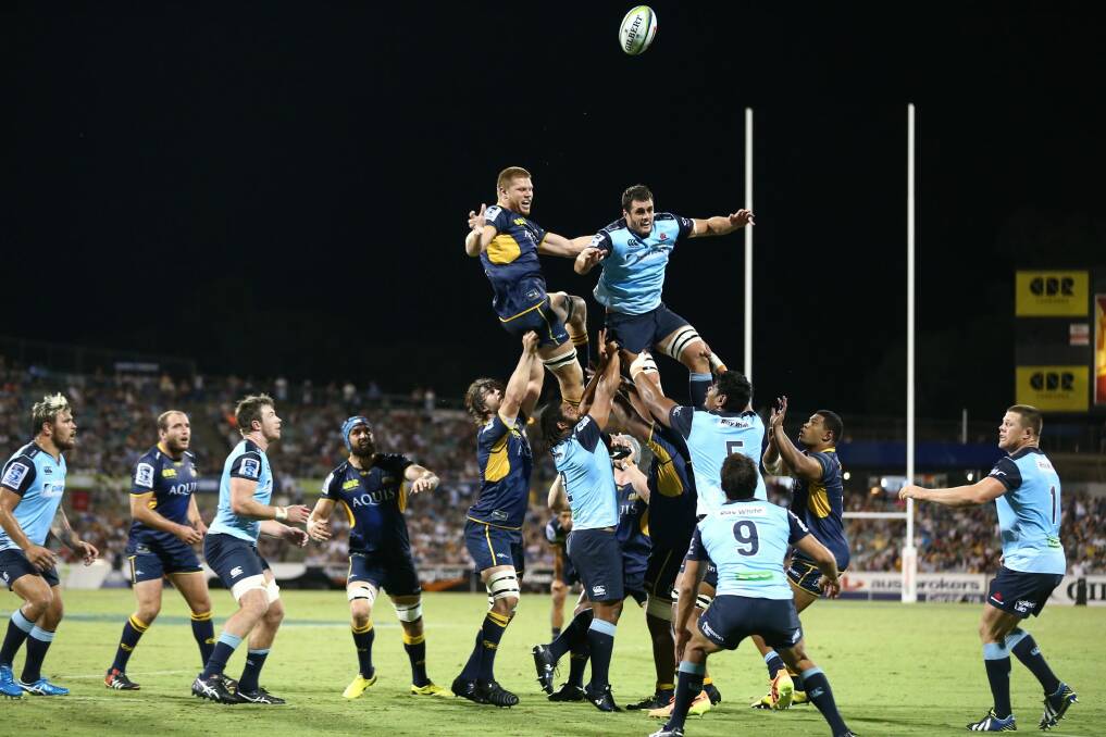 Blake Enever and Dave Dennis compete for the ball in the Brumbies-Waratahs match on Friday night. Enever injured his shoulder in the second half. Photo: Alex Ellinghausen