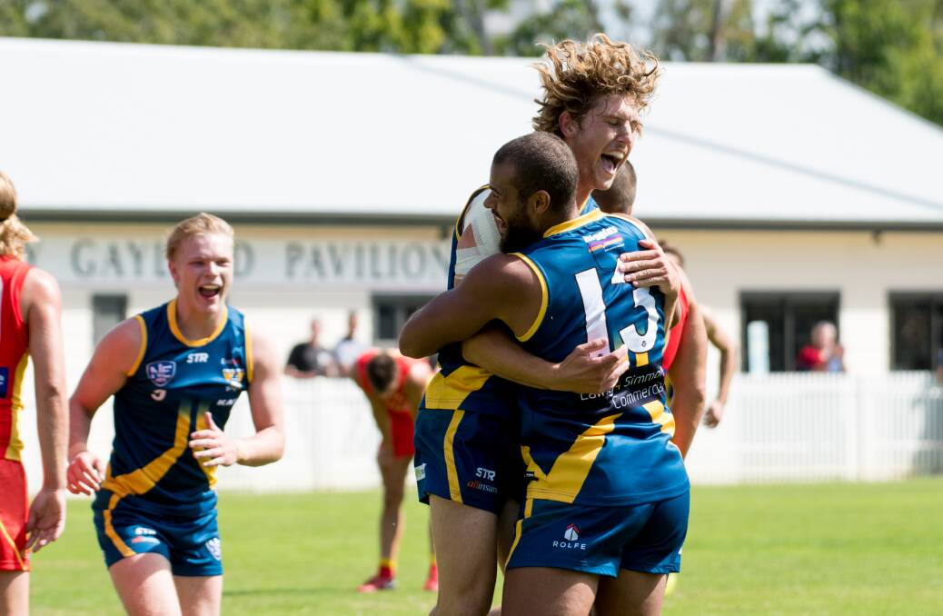 Canberra Demons player Kel Evans celebrates with Tom Faul. Photo: Elesa Kurtz