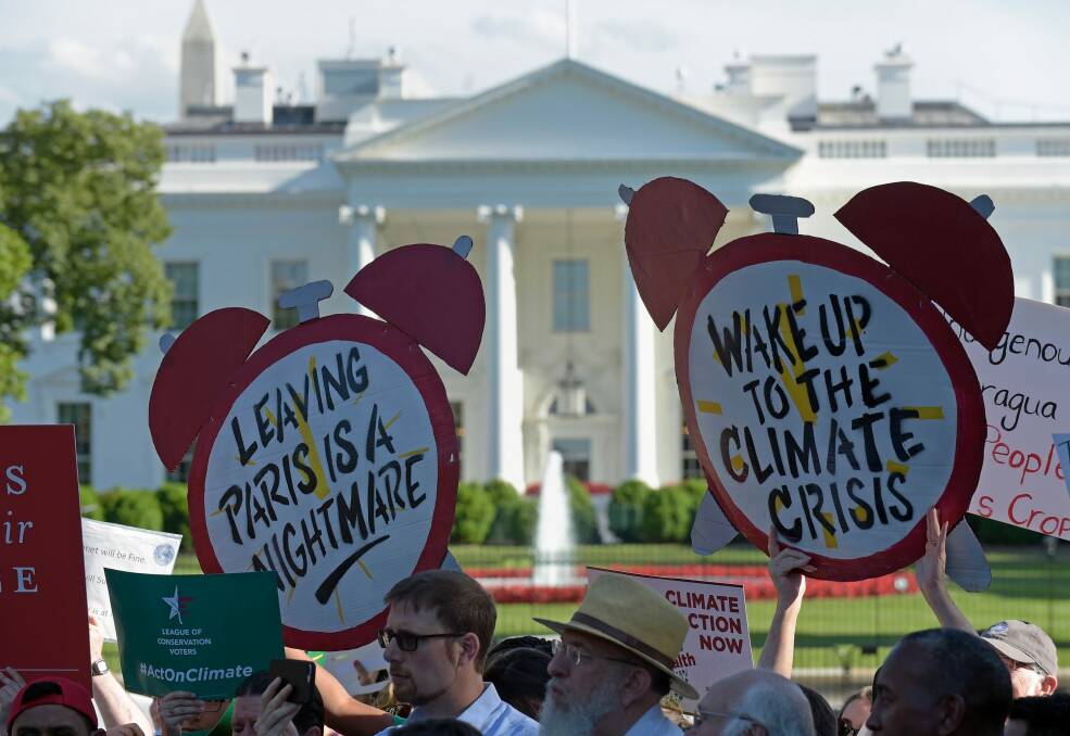 Climate protesters gather outside the White House against Trump's decision. Photo: AP