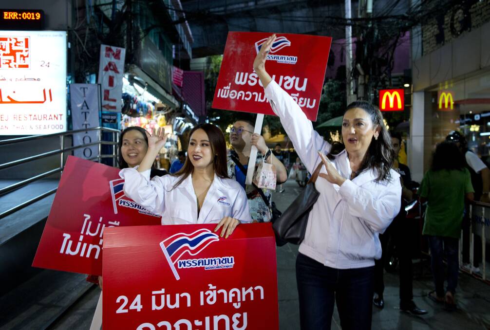Pauline Ngarmpring, right, a transgender person and a prime ministerial candidate, and Namklenginarin, centre, a candidate for the parliament, greet people in Bangkok. Photo: AP
