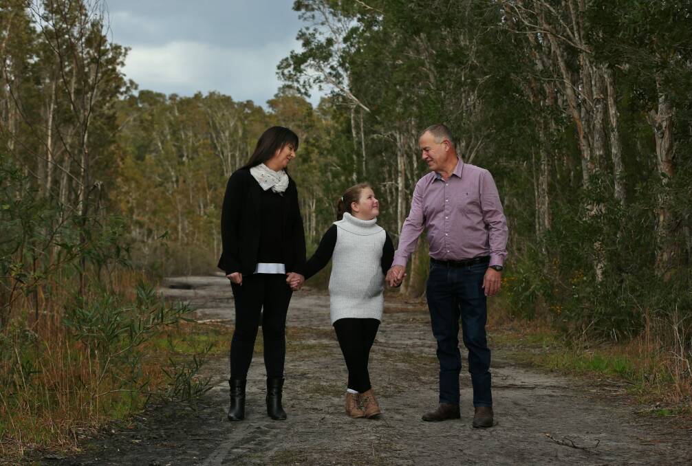 Ian and Carolyn Thomson, the parents of the late Canberra track worker Riharna Thomson, with their younger daughter Bessie, seven, at their home in Salamander Bay on Friday. They say confronting the issue of Riharna's organ donation was difficult but ultimately the best thing for their recovery. Photo: Simone De Peak