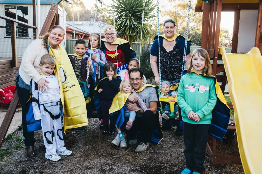Family and friends of Jessica Russell wearing yellow capes ahead of the Children's Tumor Foundation's mega hero walk on Sunday. Photo: Rohan Thomson