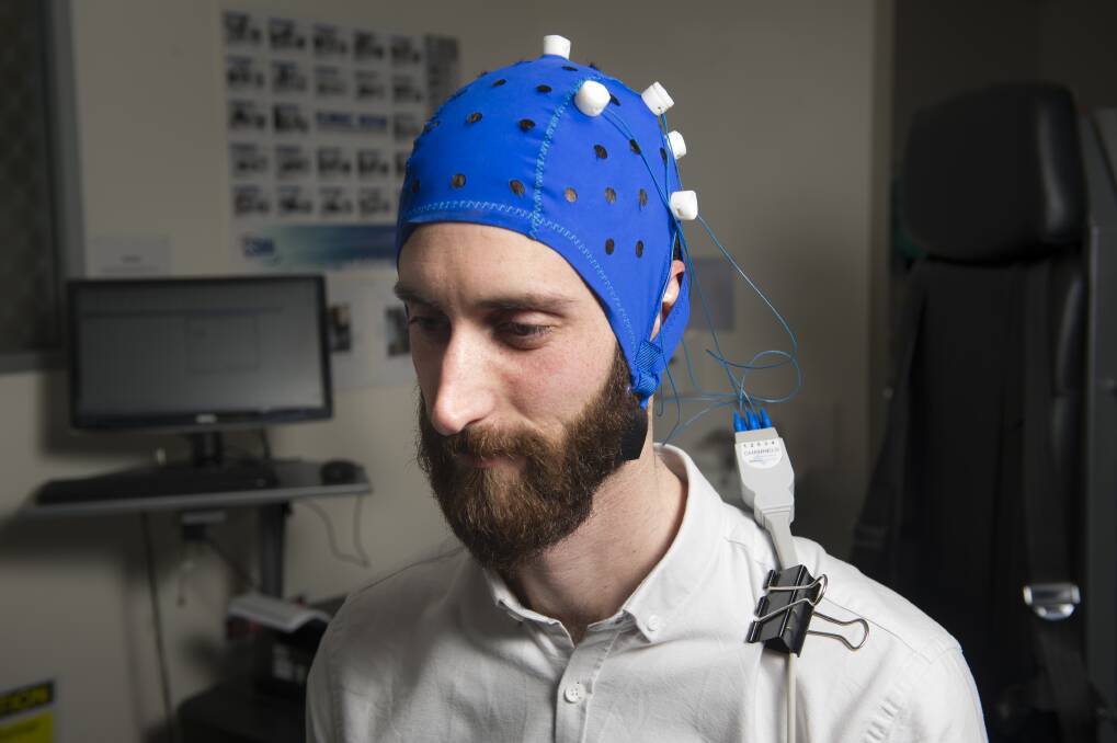 University of Canberra assistant professor Andrew Flood demonstrates the transcranial direct current stimulation device used to deliver electric current to the brain.  Photo: Elesa Kurtz