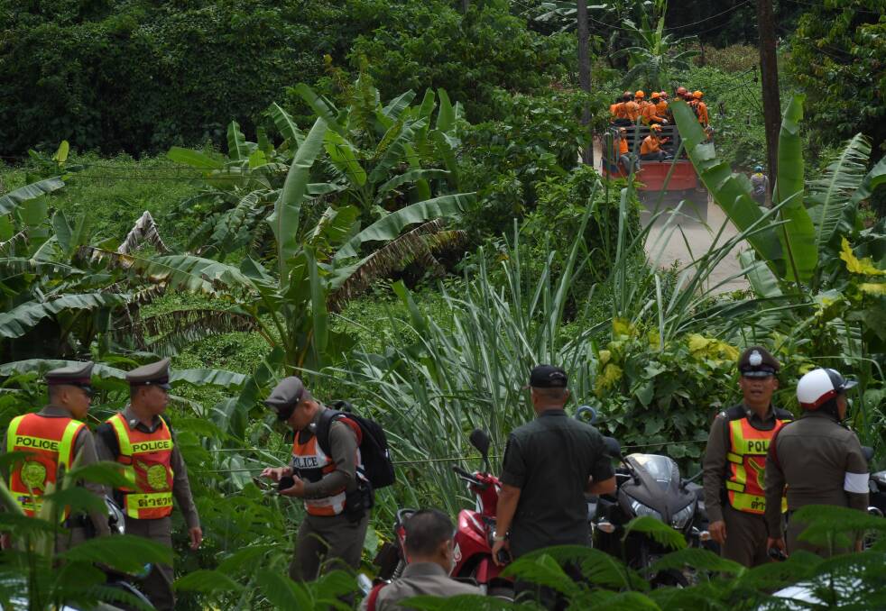 Thai rescue volunteers make their way up to the base camp near Tham Luang cave on Monday.  Photo: Kate Geraghty