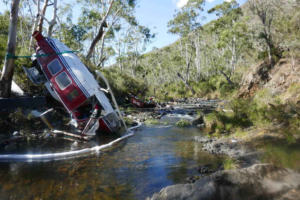 The wreckage of a UH-1H helicopter lies in the Yarrangobilly River after it was destroyed in a crash in April. Photo: Australian Transport Safety Bureau