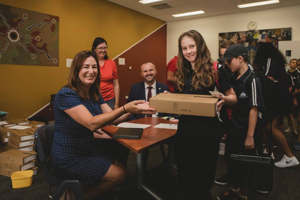 ACT Education Minister Yvette Berry gives Year 7 student Bri Wolstencorft her new computer. Photo: Jamila Toderas