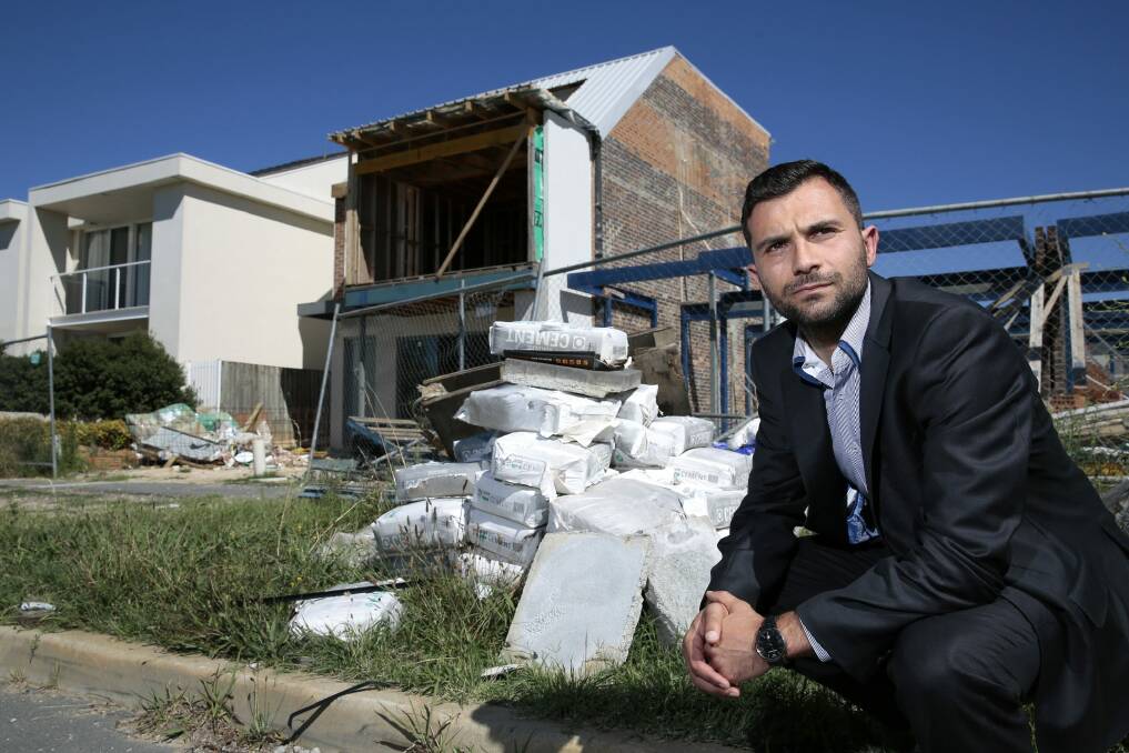 Concerned property owner Goran Josifovski in front of one of the 11 vacant  blocks where work has started than stopped on Phyllis Ashton Circuit in Gungahlin.  Photo: Jeffrey Chan.