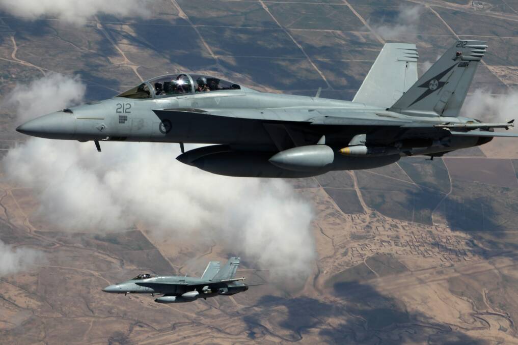 An Australian F/A-18F Super Hornet and an F/A-18A Hornet patrol the skies over Iraq.  Photo: Supplied