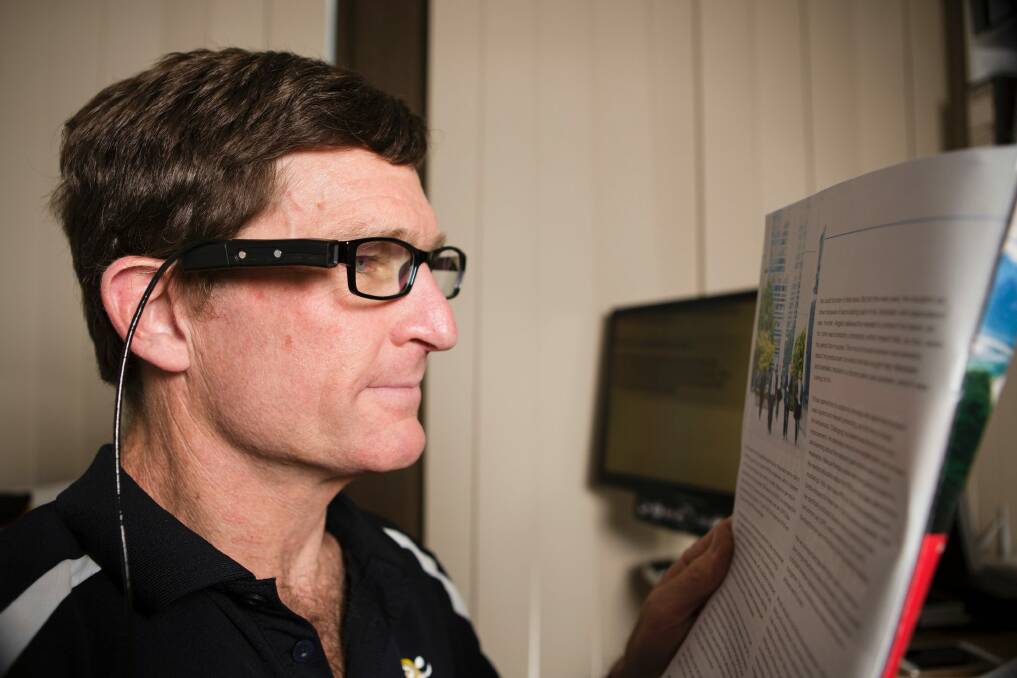 Roy Daniell is one of the first people in the ACT to try out the OrCam MyEye, a device that helps people with vision impairments. The device is clipped to the side of his glasses.  Photo: Jamila Toderas