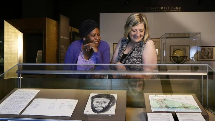 Jessie Mabo with Yvonne Thompson from Melbourne, one of the Human Brochures, take a look at papers that belonged to Jessie's father Eddie Mabo. Photo: Jeffrey Chan