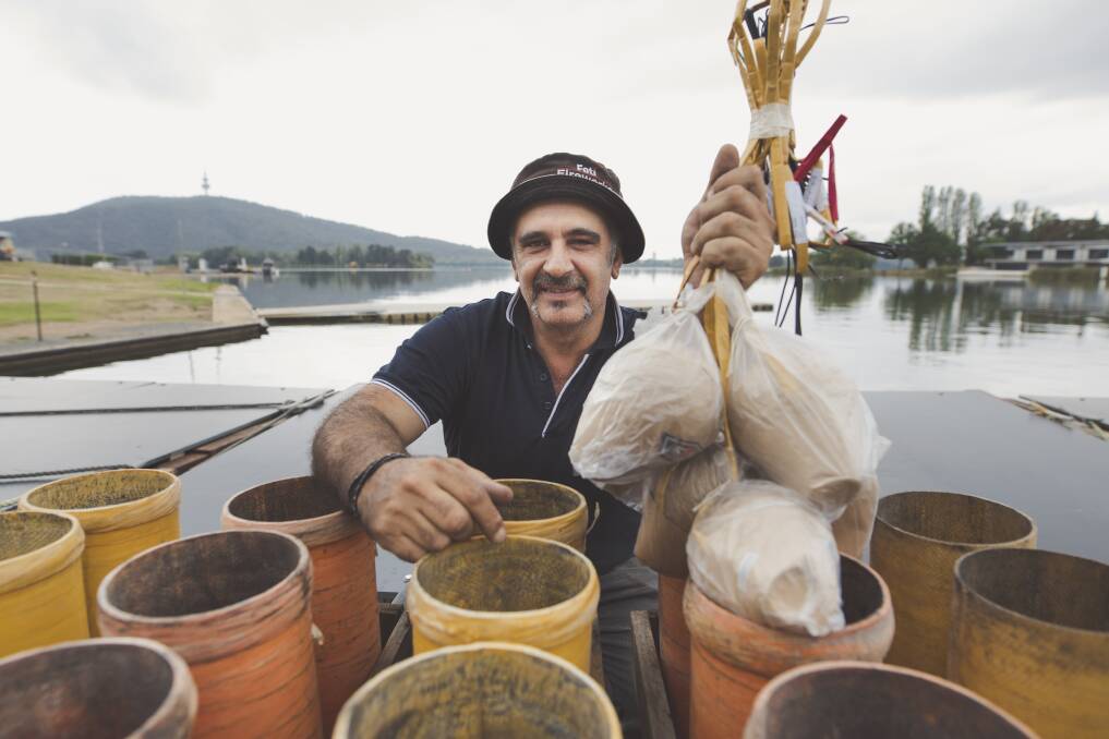 Pyrotechnician Fortunato Foti, pictured, packs mortars on Lake Burley Griffin on Thursday ahead of Saturday night's Skyfire. Photo: Jamila Toderas