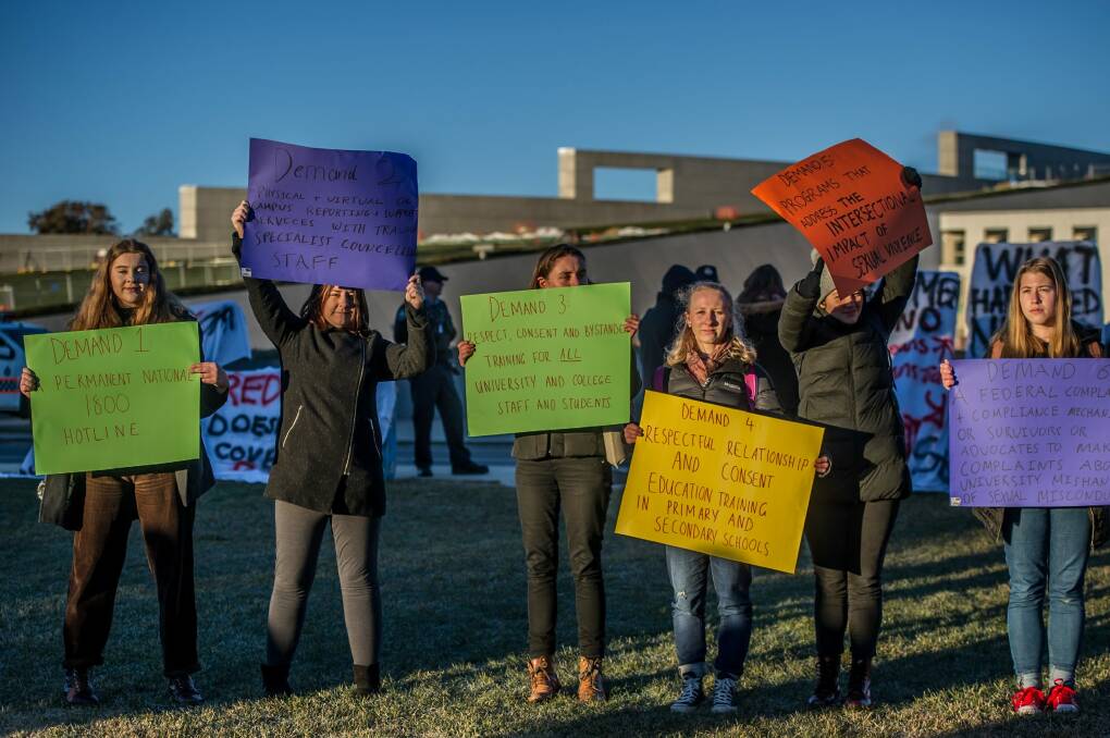 Students hold placards detailing demands. Photo: Karleen Minney