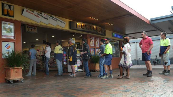 The line for a lotto ticket, which jackpots to $100 million tonight, stretches out the door at the Dickson newsagency yesterday. Photo: Graham Tidy