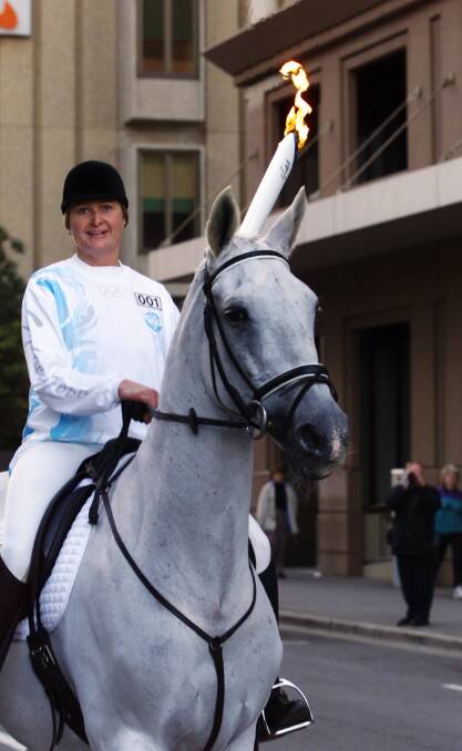 Olympic gold medalist Gillian Rolton on her beloved horse Fred takes the torch on its first leg of the Olympic torch relay in Adelaide ahead of the 2000 Sydney games.  Photo: John French