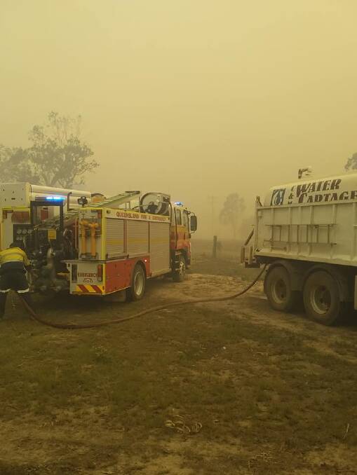 Firefighters position themselves to attempt to control the blaze. Photo: Leslie Cullen
