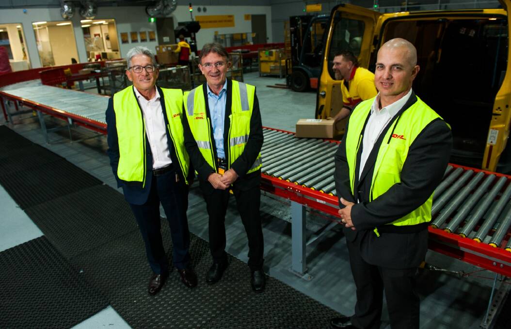 DHL Express Oceania CEO Gary Edstein, global chief of express services Ken Allen and local branch manager Careg Pretorius with courier Tony Kingston at the new freight forwarding facilities in Fyshwick. Photo: Elesa Kurtz