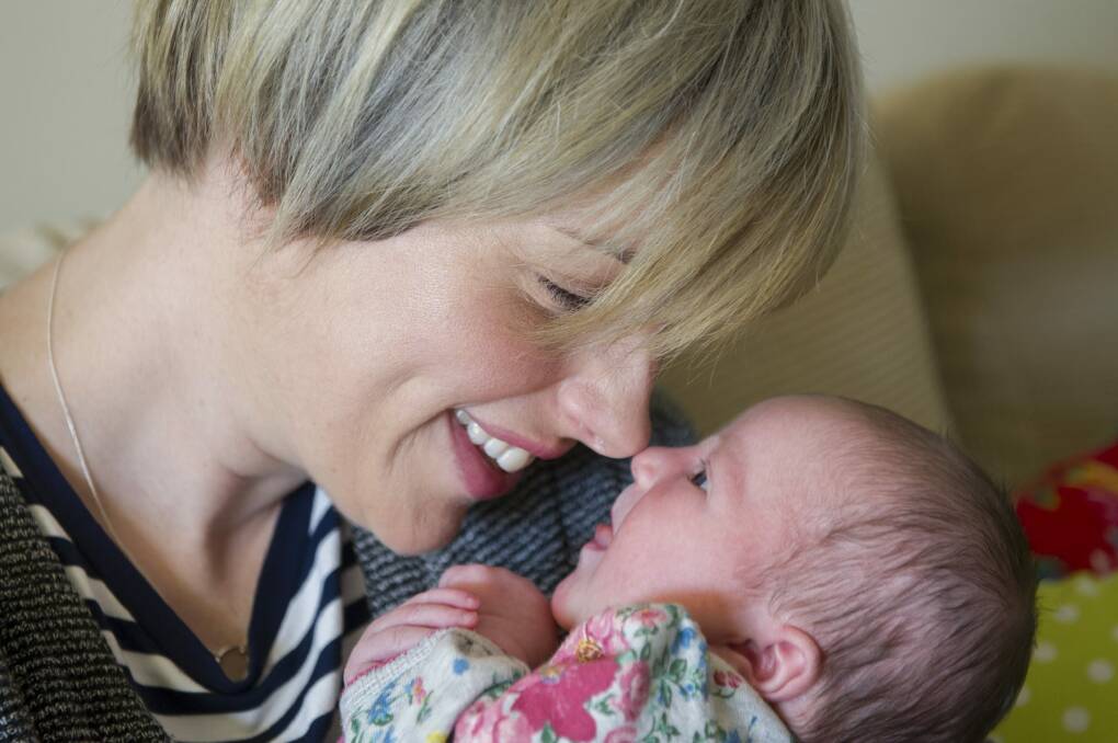 <i>The Voice's</i> Amber Nichols at home in Canberra with new baby Olive. Photo: Jay Cronan