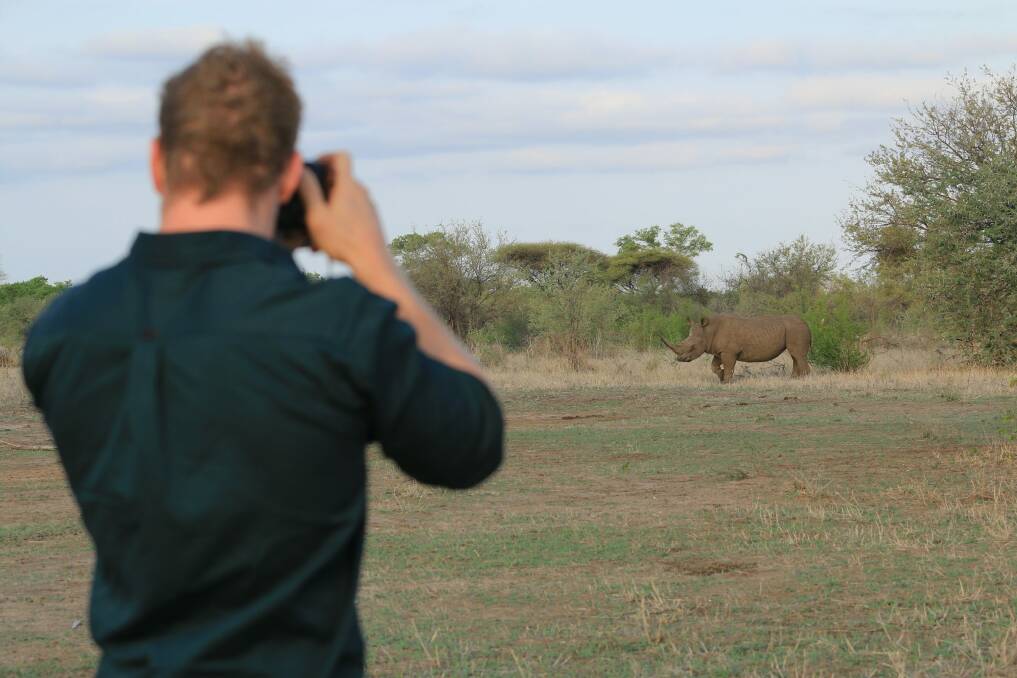Pocock photographing a white rhino in the old country. Photo: ABC/Winsome Denyer
