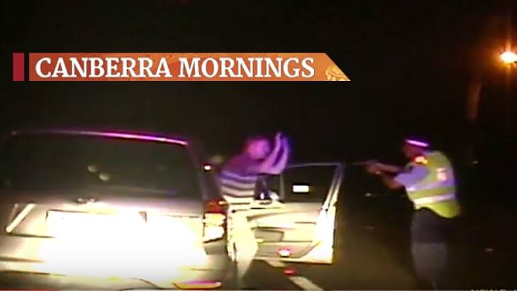 Dramatic dash cam footage shows a NSW Police senior constable pull a gun on Canberra man.