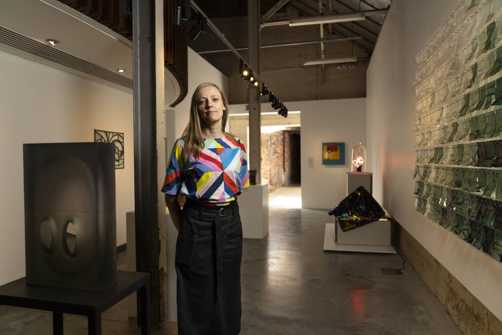 Canberra Glassworks artistic director Aimee Frodsham in the new exhibition Illuminated Spaces.  Photo: Lawrence Atkin